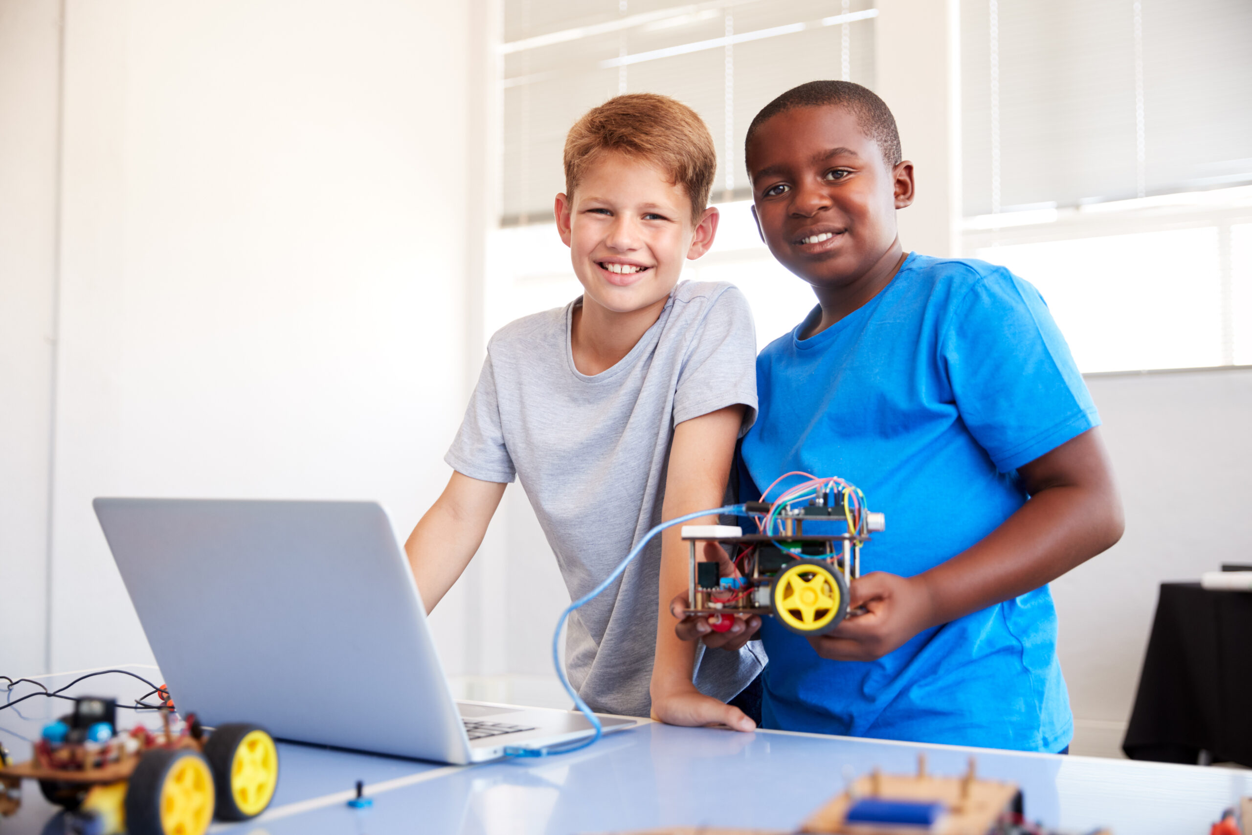 Portrait,Of,Two,Male,Students,Building,And,Programing,Robot,Vehicle